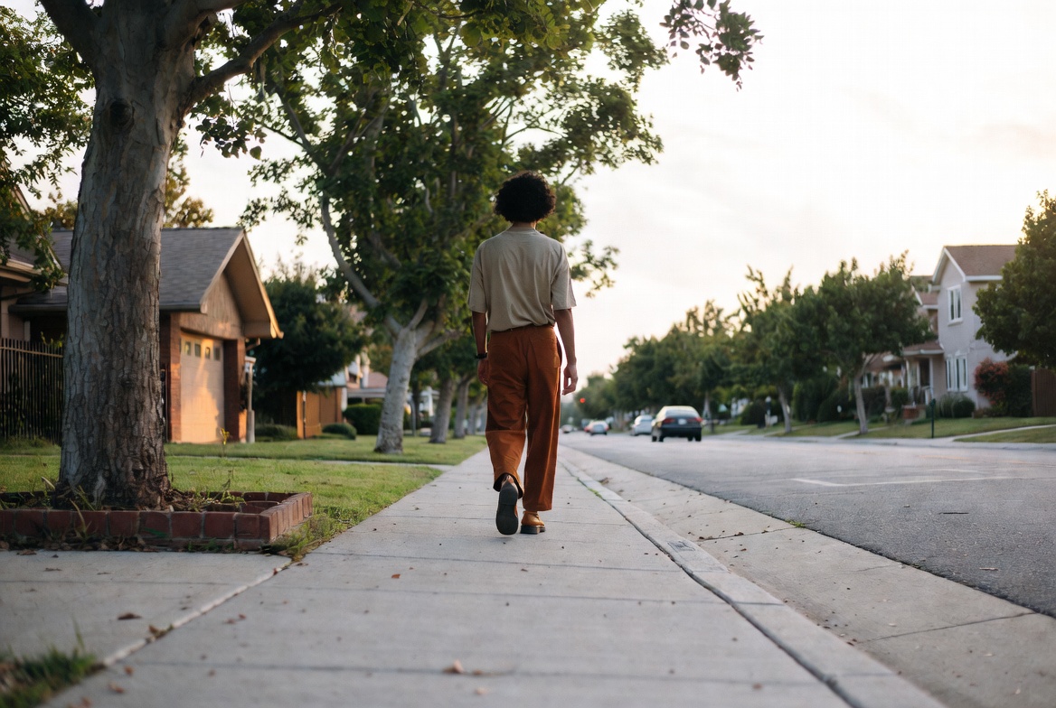 Person walking on quiet neighborhood sidewalk